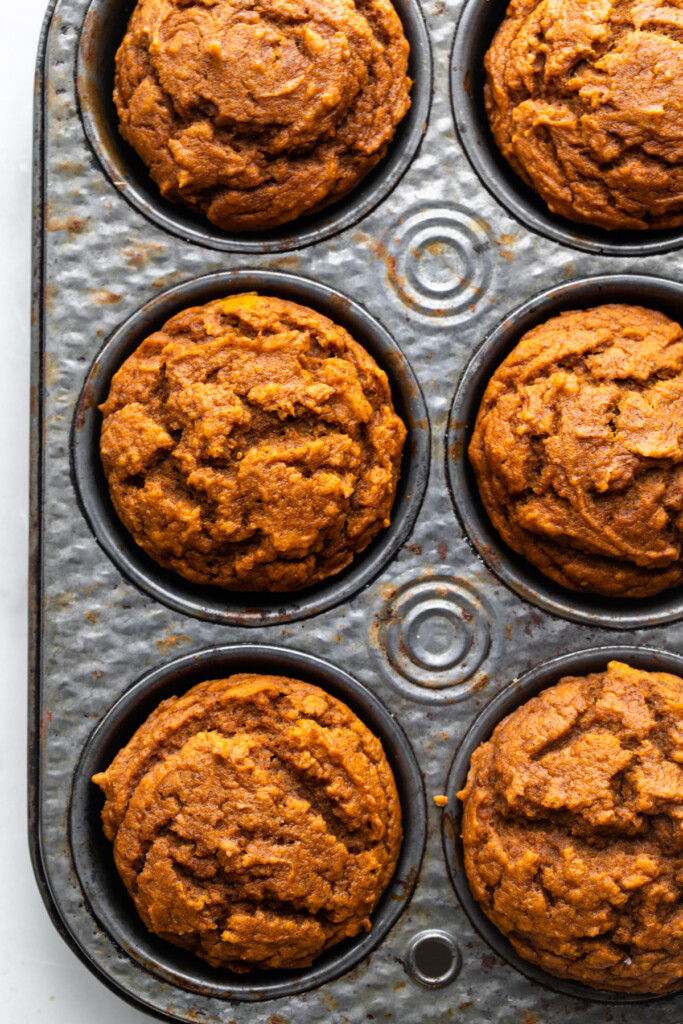 close up view of Vegan Pumpkin Muffins in a muffin pan